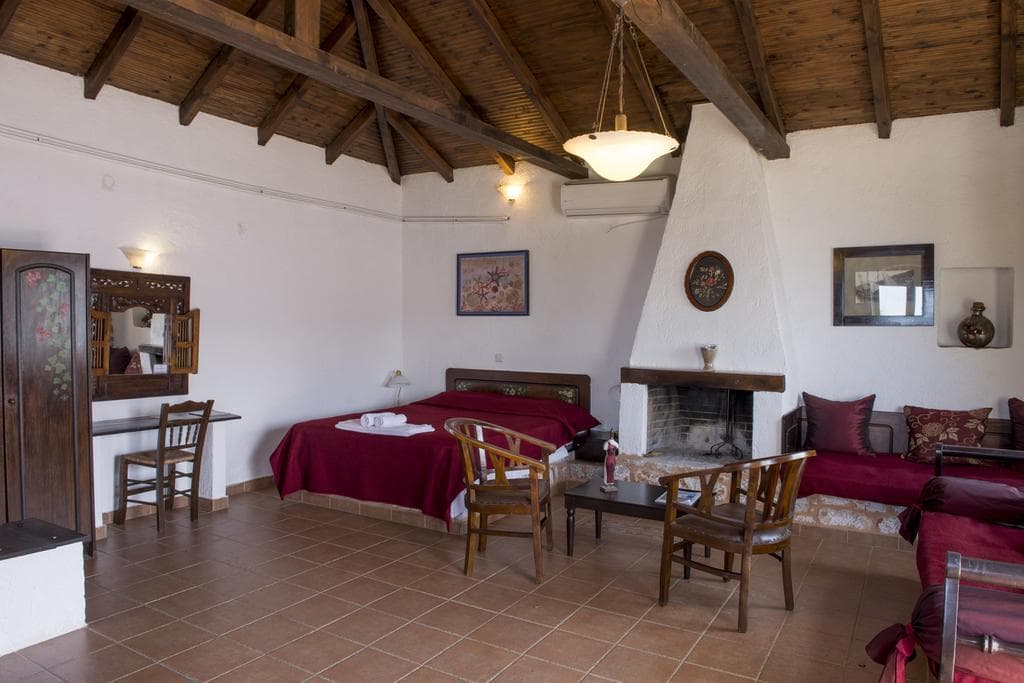 A bedroom with a traditional Mani bed frame