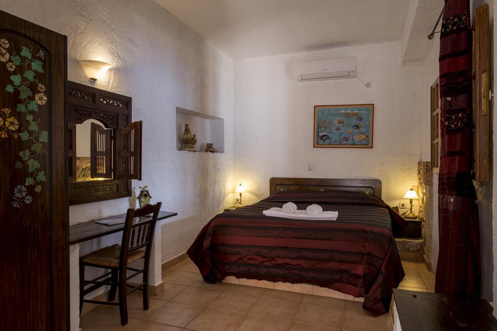 A studio interior with stone walls and traditional furniture